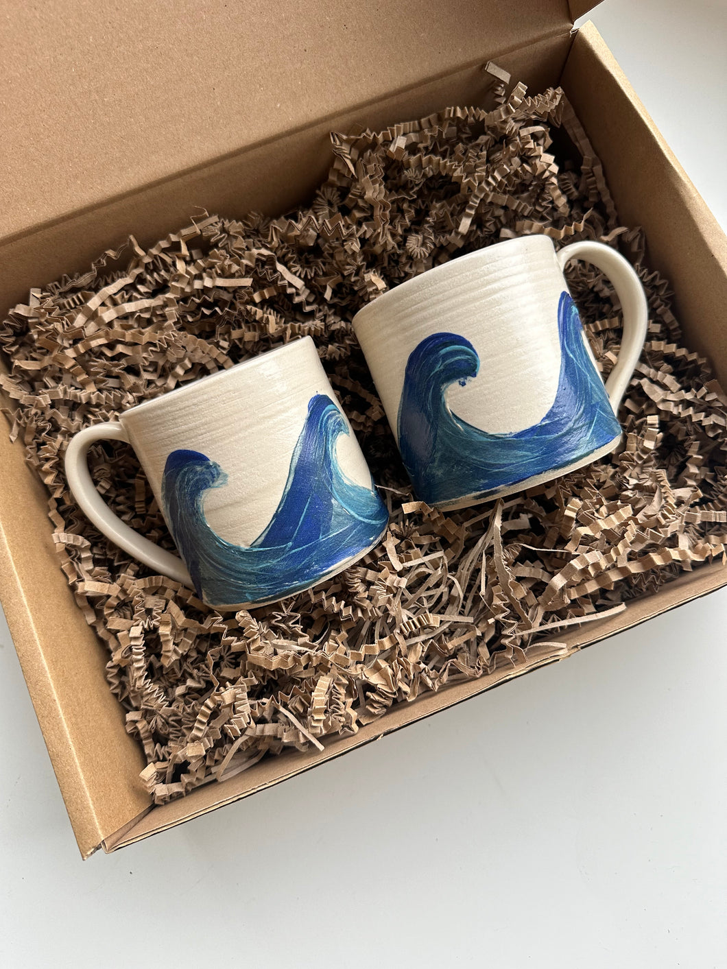 Wheel thrown ceramic mugs with wave decoration